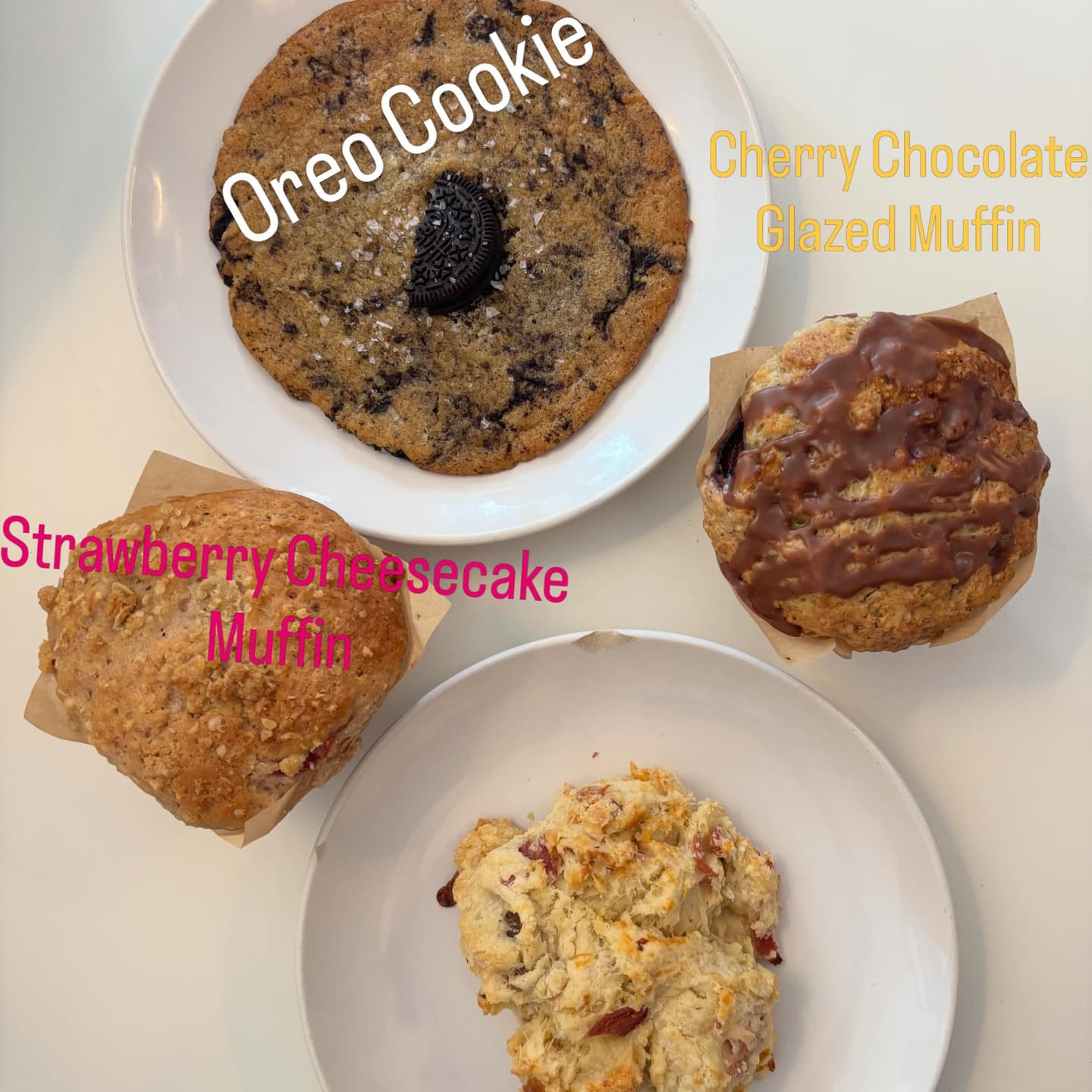 Bake case with labeled cookies, muffins, and biscuits