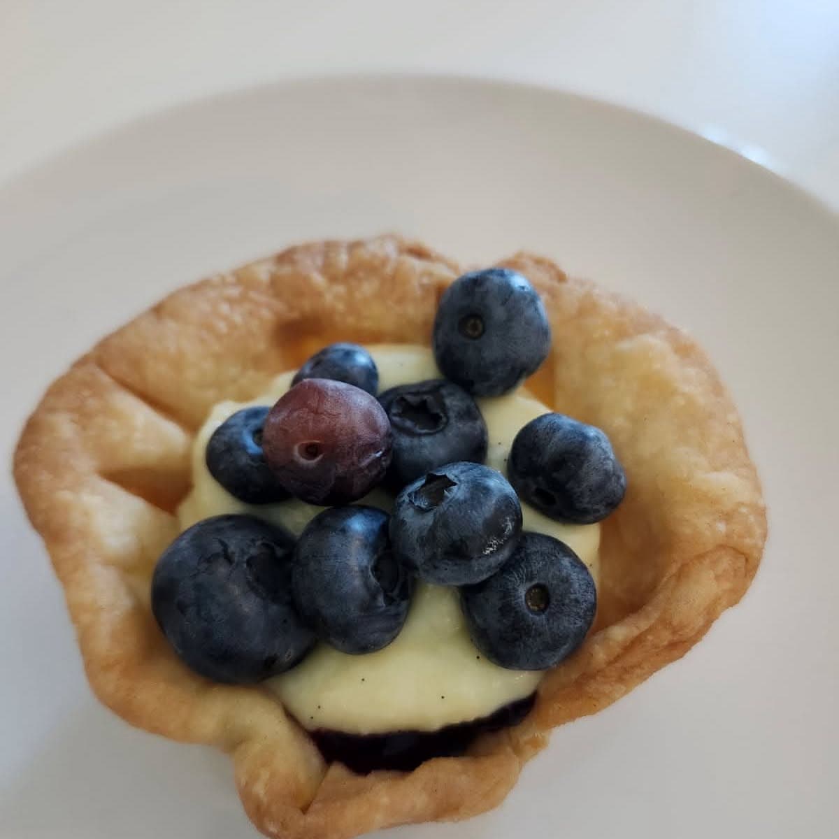 Vanilla custard tart topped with fresh blueberries