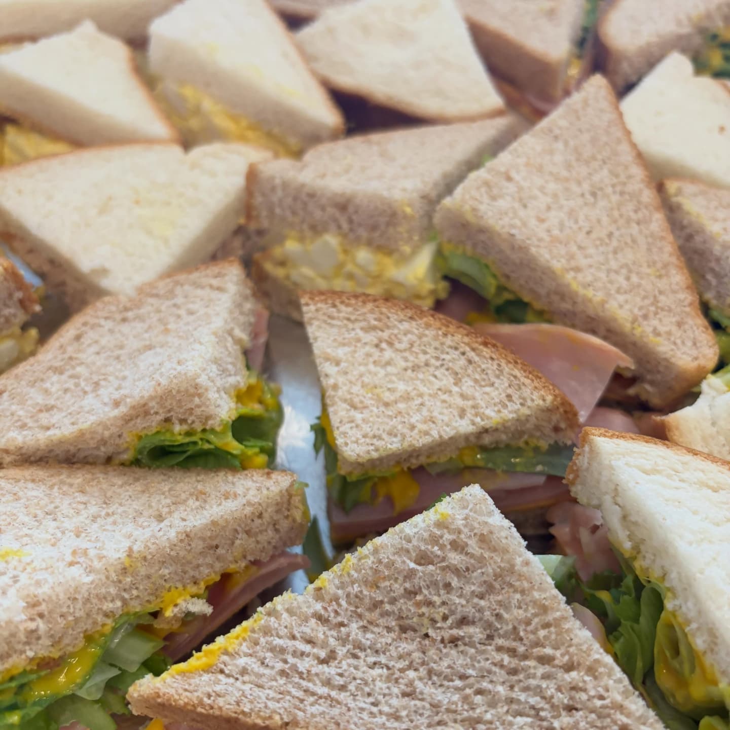 Close-up of a layered sandwich cut to show fillings